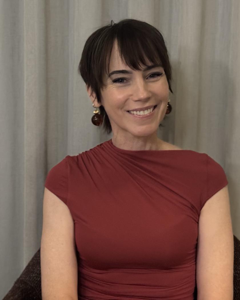 Dr Elizabeth Winlo, smiling, in an oxblood dress.